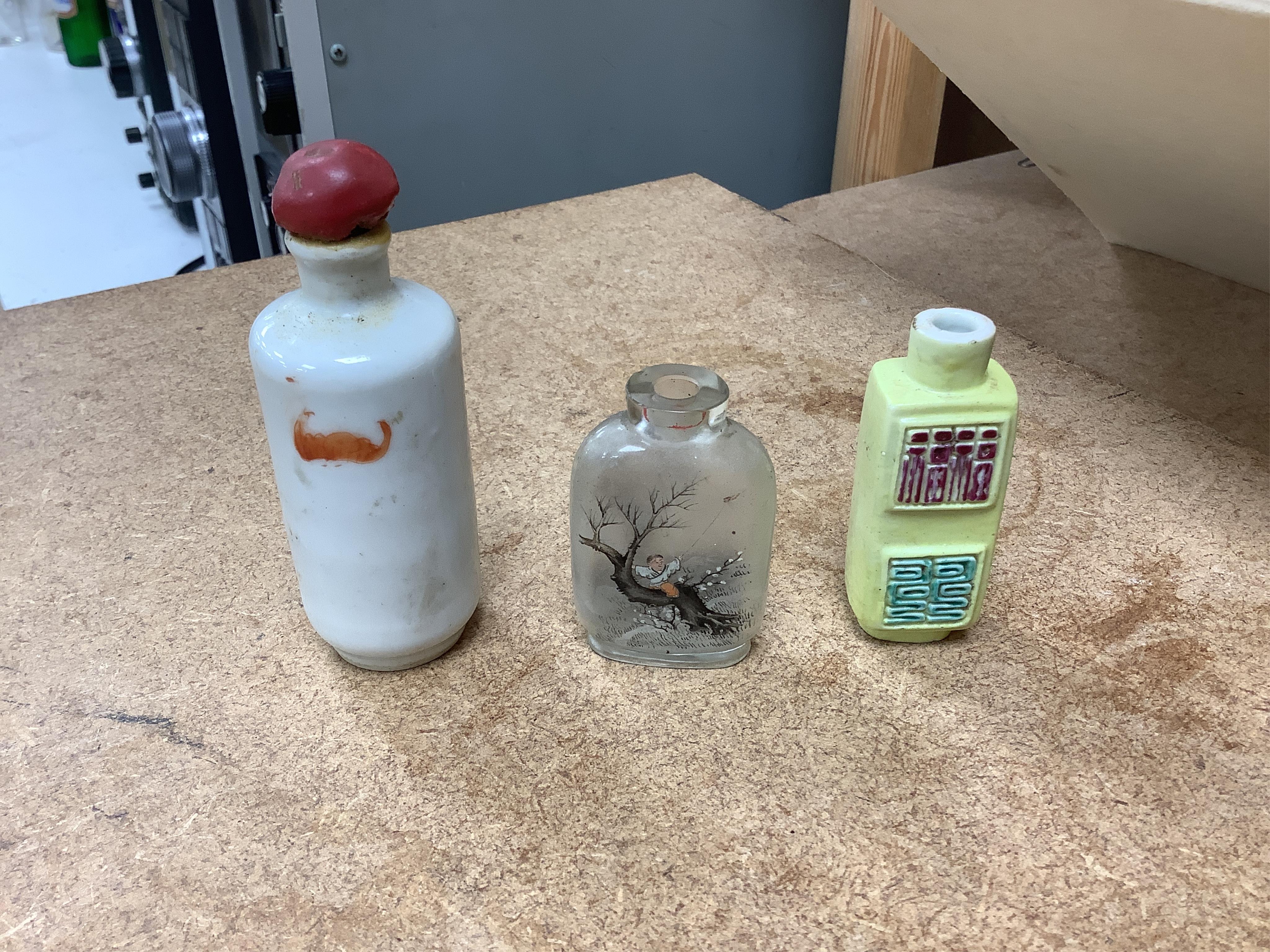 A small collection of Chinese snuff bottles, 19th century and later to include reverse glass painted examples and cinnabar lacquered examples, largest 9.5cm high
